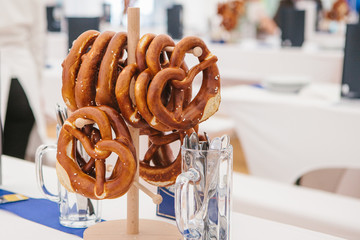 Celebration of the famous German beer festival Oktoberfest. Traditional pretzels called Brezel hang...