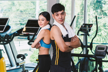 Fototapeta premium Sport man and woman with towel stand at the gym.fitness and lifestyle concept