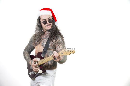 Inked Santa Clause with sunglasses playing guitar, white background