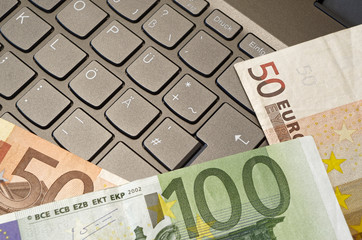 Euro banknotes lying on a keyboard with german layout