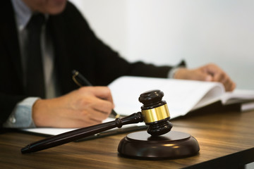 justice lawyer / judge gavel working with legal documents in a court room