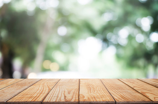 Empty Wood Table In Front Of Blurred Montage Nature In The Garden Background