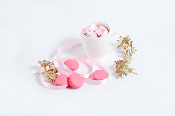 breakfast, morning coffee with marshmallows and macaroons, on white background. The concept of the beginning of the day.