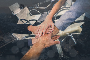 Business partners teamwork. Multi-ethnic diverse group of colleagues join hands together. Creative team, coworkers, or college students in project meeting at modern office. Double Exposure