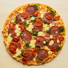 Baked pizza "salami mozzarella pesto". Fast and junk food concept