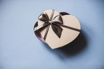 Fototapeta na wymiar Heart shaped gift box on a blue background top view.