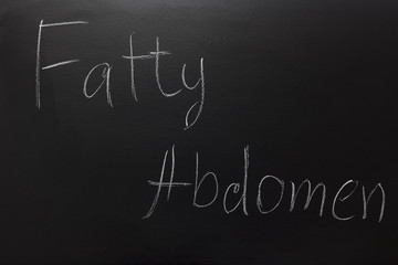 Obraz premium Fatty abdomen text written on blackboard