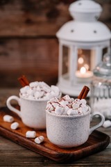Obraz na płótnie Canvas Christmas drink. Hot chocolate with marshmallows and cinnamon on dark wooden background.