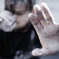 Close up of man holding a glass of vodka