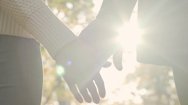 Romantic Couple Slowly Grab Hands After A Small Argument, Symbol Of Reunion