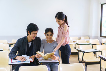 Students man and woman reading book preapare for exam highschool in classroom at school. concept of education people learning and tutorial academy.