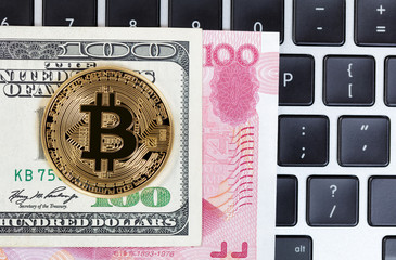 Bitcoin cyber single coin on keyboard with mixed paper currency background