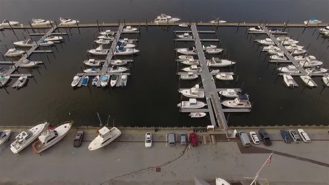 Aerial View Of Great Kills Harbour. Camera Moving Forward Fast From Over The Land Descending To Moored Boats And Then Rising Again. Concept Of Landing Place.