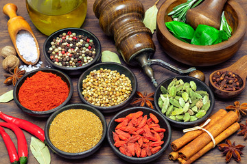Spices and herbs on wooden background