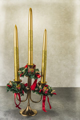 Candlestick with christmas decoration on the grunge background