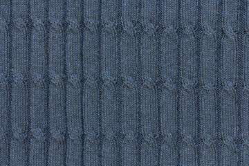 dark blue background with cable pattern, texture of knitted fabric