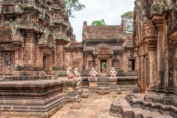 Banteay Srei, a 10th century Hindu temple dedicated to Shiva. The temple built in red sandstone was forgotten for centuries and rediscovered 1814 in the jungle of the Angkor area of Cambodia.  - obrazy, fototapety, plakaty
