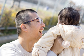 Fototapeta premium A Japanese man holding a child