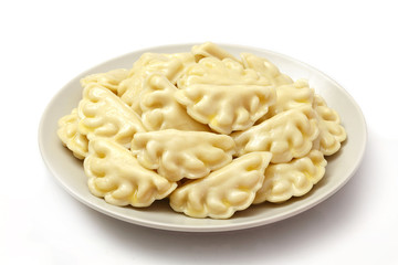 Meat dumplings - russian pelmeni, ravioli with meat on a plate on a white background, isolated