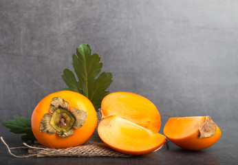 kaki fruit on a stone background