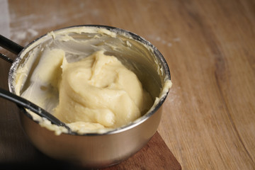 female hands mixing choux dough