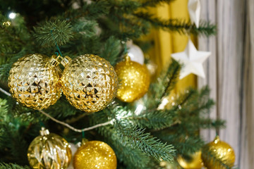 Christmas decoration with many glitter bauble balls, shinny baubles and pine cones on the artificial pine tree
