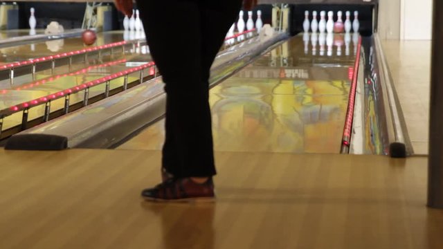 People playing a game of bowling at the small town bowling alley