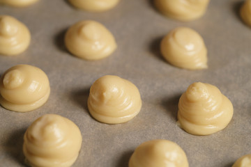 choux dough for profiteroles on baking paper