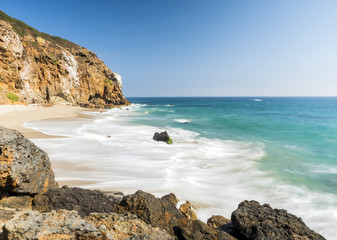 Fototapeta na wymiar Dume Cove Malibu, Zuma Beach, emerald and blue water in a quite paradise beach surrounded by cliffs. Dume Cove, Malibu, California, CA, USA