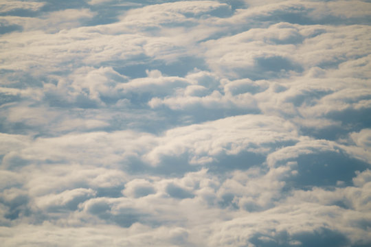 Aerial Shot From Plane Flying Above The Clouds In Daytime