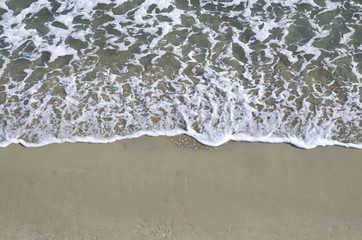 Top view od small waves on sandy beach