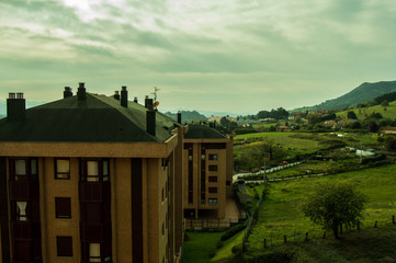 landscape of a natural area with buildings in a cloudy day. Asturias, Spain.