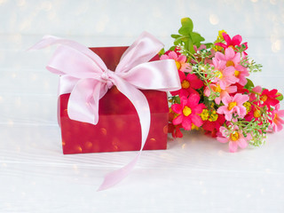 Small gift box decorated with ribbon and flower, Beautiful romantic gift box on wood
