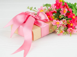 Small gift box decorated with ribbon and flower, Beautiful romantic gift box on wood