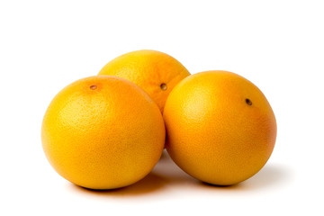 Three ripe grapefruit on white