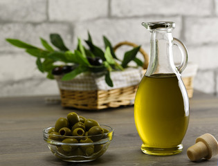 Olive oil and olive branch on the wooden table