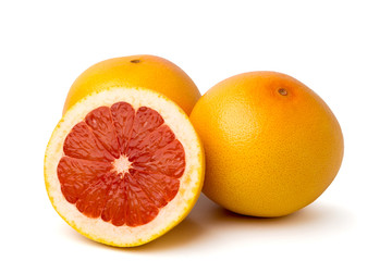 Ripe grapefruit and half on white