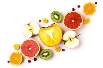 Background of ripe fruit cut in half kiwi, persimmons, tangerines, apples.