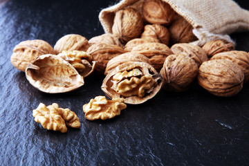 Walnut. Walnut kernels and whole walnuts in burlap sack.