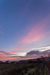 Colorful sunset over a field foreground