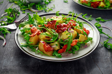 Fresh crispy Bacon, Potato salad with green vegetable on plate