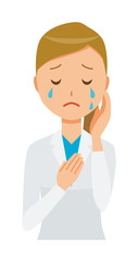A woman doctor wearing a white suit is crying