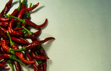 Pile of organic red chillies or chilli peppers isolated on a white background.