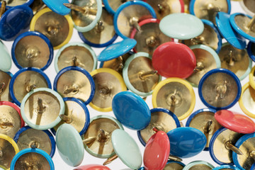 Many different colorful thumbtacks, colorful background or texture