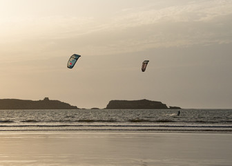 Early evening kite surfing as the sun starts to set over the ocean