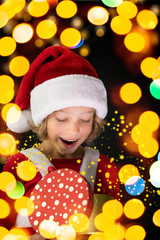 Surprised child holding Christmas gift box