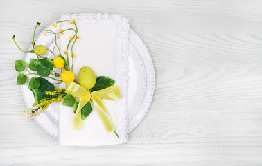  Spring Table Setting for Easter with eggs and leaves. Copy space