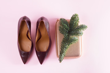 Hight heel shoes, golden bag and evergreen tree twig, dressing up for Christmas party, flat lay scene
