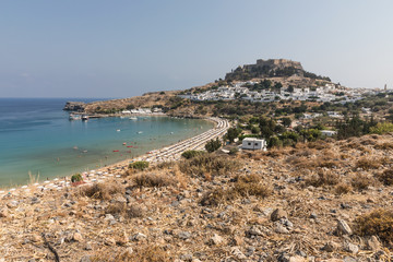 Acropolis, the second largest and most significant in Greece, and white houses in Lindos on the...