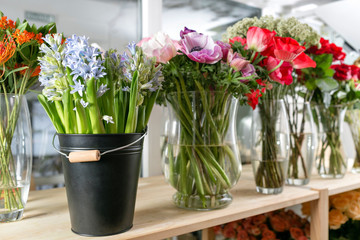 Fototapeta na wymiar different varieties. Fresh spring flowers in refrigerator for flowers in flower shop. Bouquets on shelf, florist business.